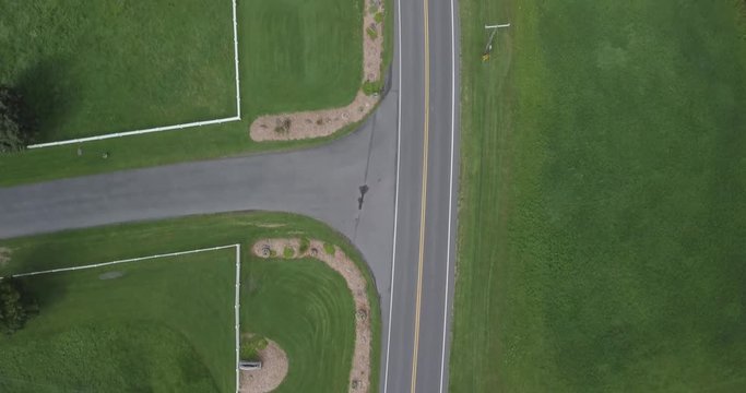 A drone shot from above, which shows a road with green land around it. This was shot in Schnecksville, Pennsylvania