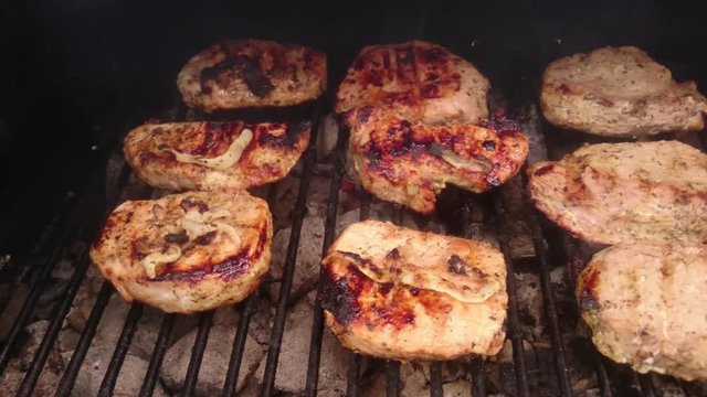 Steaks cooking on grill. Panorama from left to right.