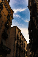 Old buildings facade on blue cloudscape in Girona, Catalonia