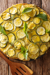 snack Italian summer zucchini tart with flowers close-up. Vertical top view