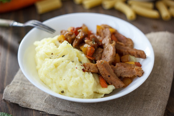 Soy meat with potato puree over kitchen table.