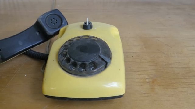 Close-up of dusty old telephone with dial. Slider view
