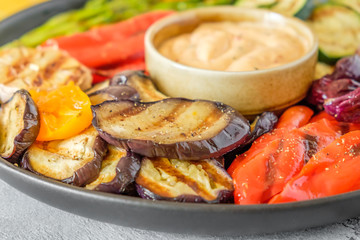 Grilled vegetables on a plate with sauce