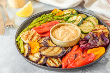 Grilled vegetables on a plate with sauce