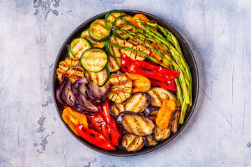 Grilled vegetables on a plate with sauce.