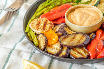 Grilled vegetables on a plate with sauce