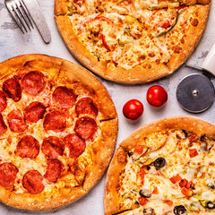 Set of different pizzas - pepperoni, vegetarian, chicken with vegetables