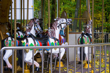 Fototapeta na wymiar Children's carousel in the autumn.