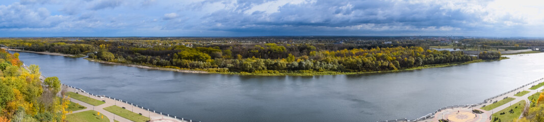 Panorama of the view of the green wood and river.