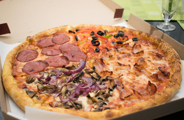 Pizza in a cardboard box.