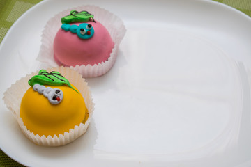 Two different colored cakes for children.