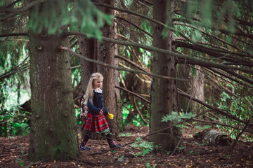 Naklejka na ściany i meble The schoolgirl goes to school for the first time through the forest with a schoolbag