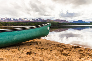 Canoe on the sandy beach of Loch Morlich in the Highlands of Scotland