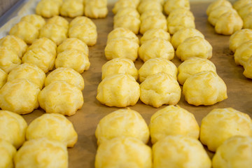 cream puffs olso known as eclair in tray.