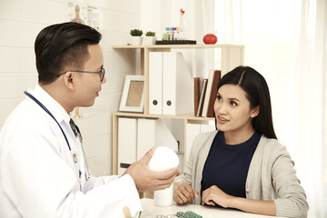 young mother is talking to a doctor