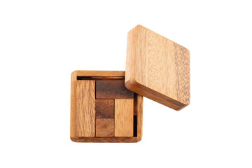 A wooden puzzle is a cube. Isolated on white background. Close-up.