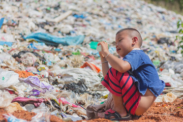 Children find junk for sale and recycle them in landfills, the lives and lifestyles of the poor, The concept poverty, child labor and human trafficking.