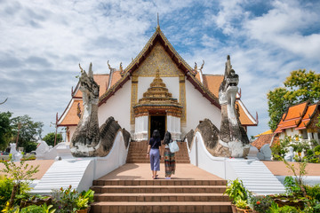 Two asian woman walking into Ancient temple