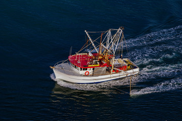 fishing trawler heading out to sea
