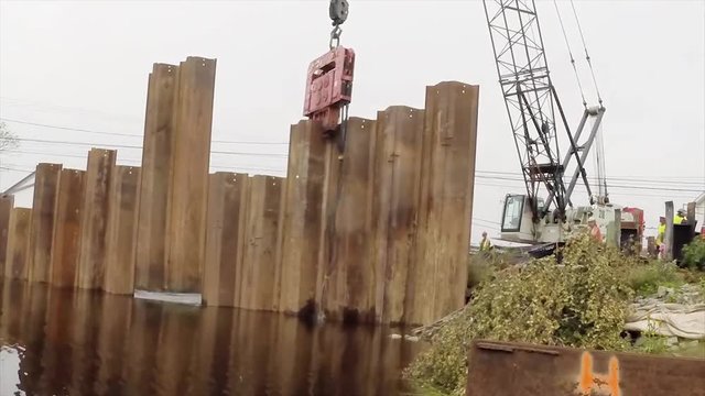 Construction of a cofferdam to keep the water level rising so a new bridge can be built