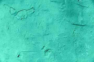 Different colors on the cracked wall.The paint is old on the wall. The texture of the wall.