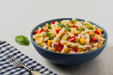 Italian fusilli pasta in a salad with ham and vegetables.
