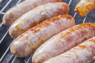 .Grilled sausages and close-up on the grill. .Delicious.tasty juicy roast meat. Cooking food outdoor.