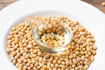 Soy bean and soy oil on  table