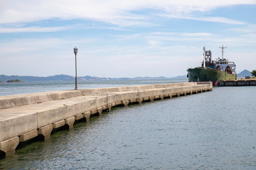 Fototapeta na wymiar Breakwater and a ship at anchor in the seto inland sea,Kagawa,Shikoku,Japan