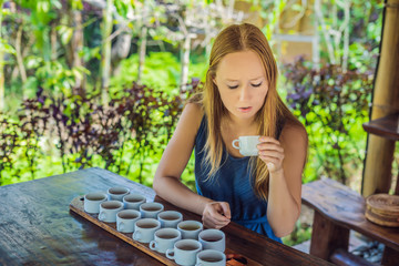 A young woman is tasting different kinds of coffee and tea, including coffee Luwak