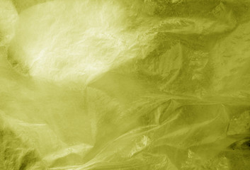 Plastic transparent old wrap texture in yellow.