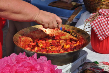 a woman mixes with a spoon of Apple jam in a large bowl
