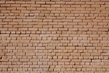 Brown color old grungy brick wall surface.