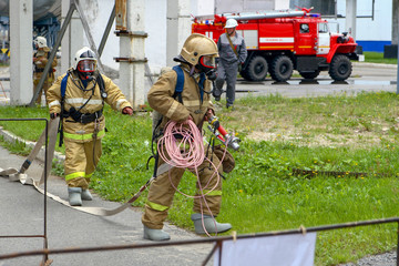 Exercises of rescuers at a chemical plant to save the victim. Rescuers flee to the scene.