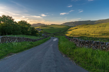 Rural road in the Yorkshire Dales near Settle, North Yorkshire, England, UK