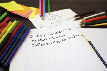 Back to school flat lay. Colour pencils, stickers and lesson notes on wooden background