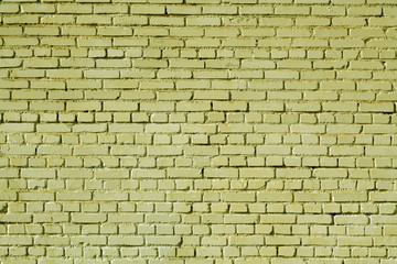 Yellow color old grungy brick wall surface.