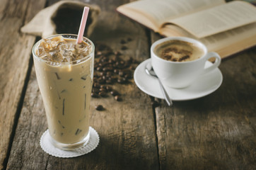 Close up of Iced Coffee on wooden table with cup of lattee and coffee beans