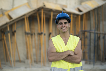 Posing construction worker smiling looking at camera