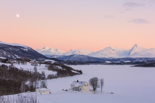 Sunrise on typical house with Lyngen Alps in the background, Mestervik, Troms county