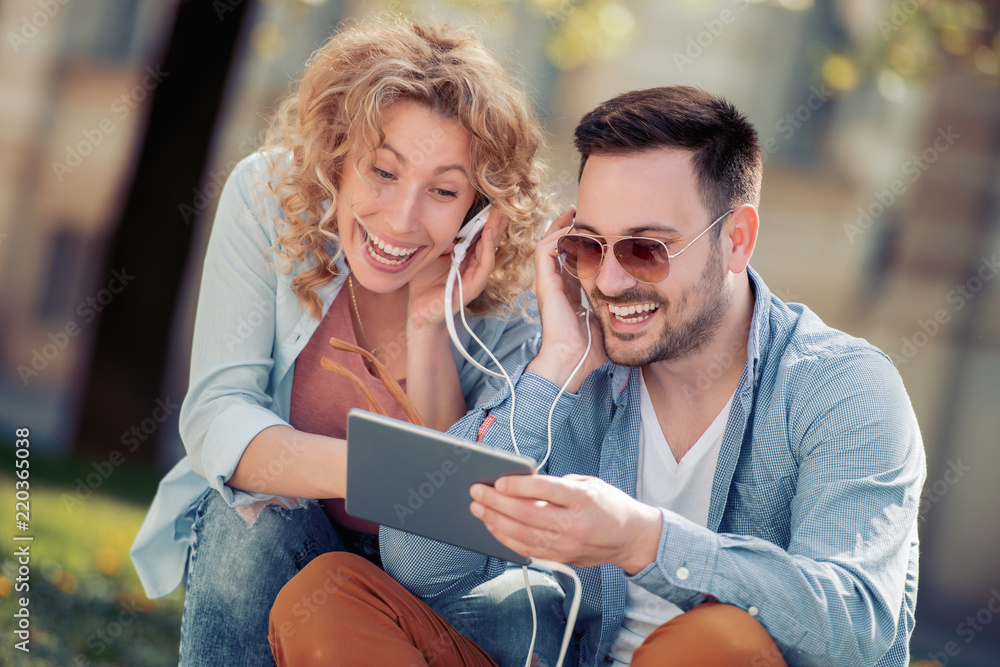 Canvas Prints romantic couple sharing headphones outdoor