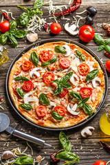 Pizza decorated with basil leaves