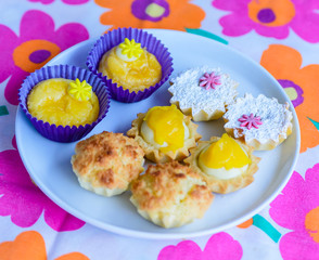 multiple colorful cupcakes of different flavors on a colorful background