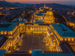 Budapest, Hungary - Aerial view of the famous Buda Castle Royal Palace at blue hour with Matthias...