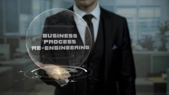 Male broker, head of crypto currency startup shows words Business Process Re-Engineering on his hand. Entrepreneur in suit holds cyber Earth hologram, presenting virtual technologies.