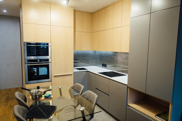Modern kitchen with wooden furniture and wooden floor
