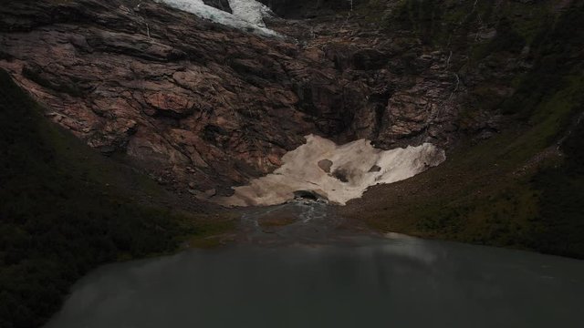 Rising aerial footage of a glacial rocky lake area in Norway