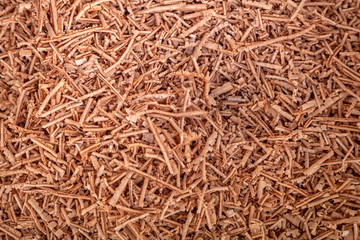 Close-up of wooden sawdust. Brown filings texture