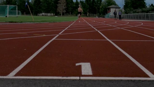 Girl starts running on a track in Oslo, Norway.
