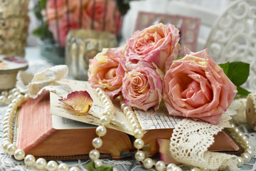 vintage style still life with roses and old book